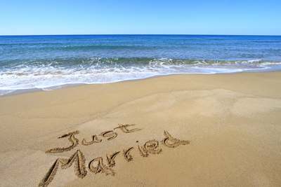 Just Married written in the sand on the beach