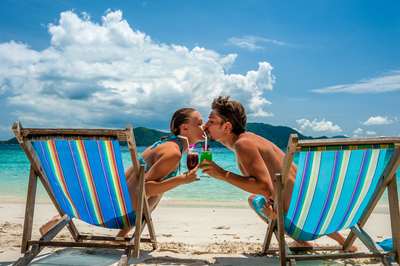 Couples kissing in beach chairs